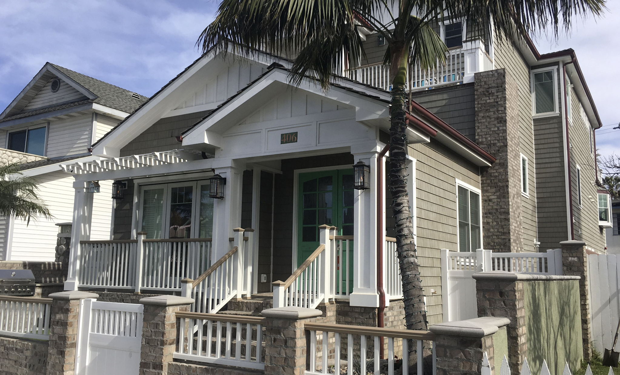 Front of the 7th Street Beach House with palm trees